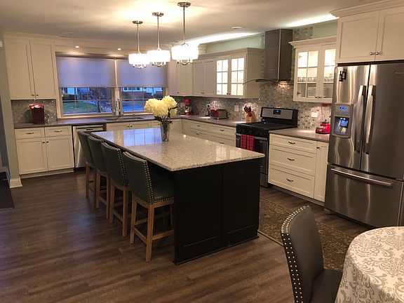 Kitchen has tons of cabinets and is open to the living area