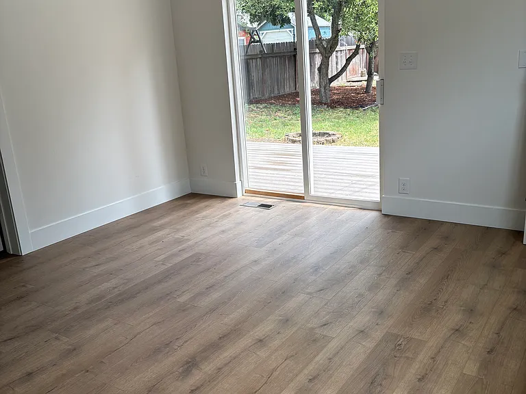 Downstairs Bedroom 2, access to back patio + yard