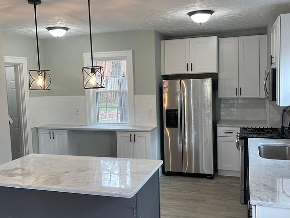 Additional view of kitchen showing additional counter space and seating area at the breakfast nook