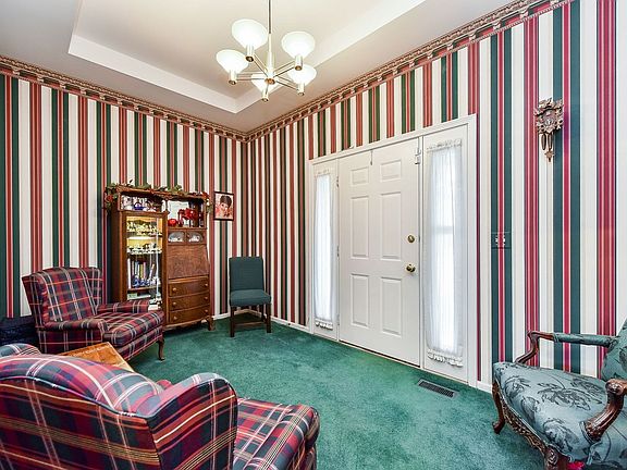 As you enter the front door you are greeted by this charming living room with a tray ceiling.  There