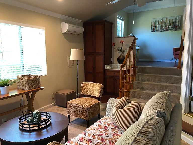 Living area, storage and steps to loft bedroom