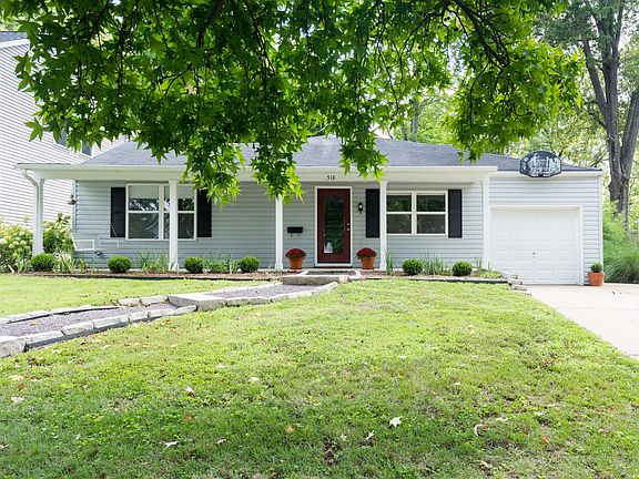 Landscaped yard with lawn care provided.