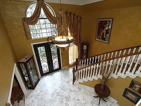 The custom details & designer touches are seen immediately upon entering. The hand-forged cantera doors ($10K), Italian marble floors, superior circular staircase, custom silk drapes, fauxed walls & drop chandelier are rich in style. (Remodeled 2011)