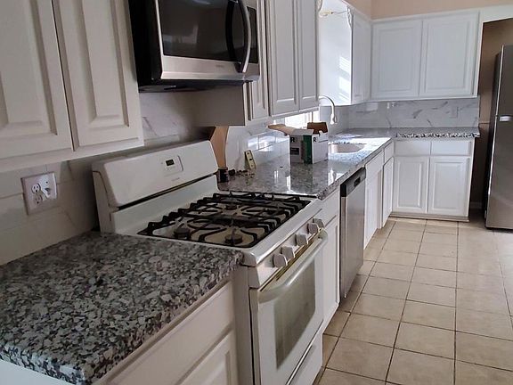 Updated kitchen with new custom cabinets, granite countertops. Brand new microwave vent hood and refrigerator, dishwasher is just 1 year old. New fluorescent ceiling fixtures.