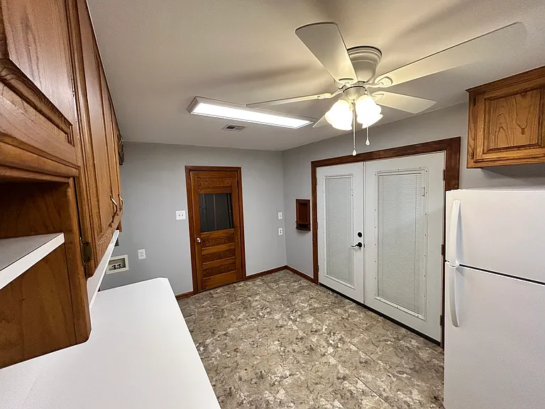 Kitchen looking at the back covered deck french doors and then the door to the garage.