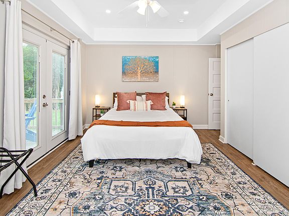 Primary bedroom (queen bed) with lots of closet space and access to side patio