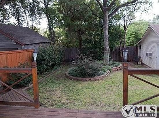 Backyard with shady pecan trees.