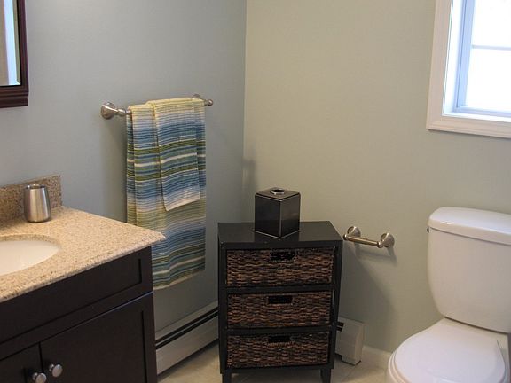 2nd floor bathroom with granite countertop and custom tile in the shower