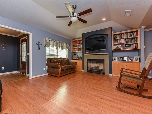 Beautiful den with tray ceilings, recessed lighting, and gas fireplace for cool winter evenings.