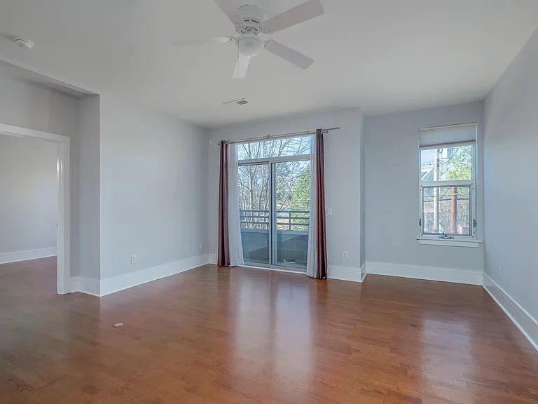View of the living room and back balcony from the kitchen.