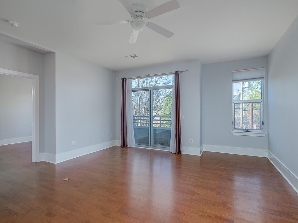 View of the living room and back balcony from the kitchen.