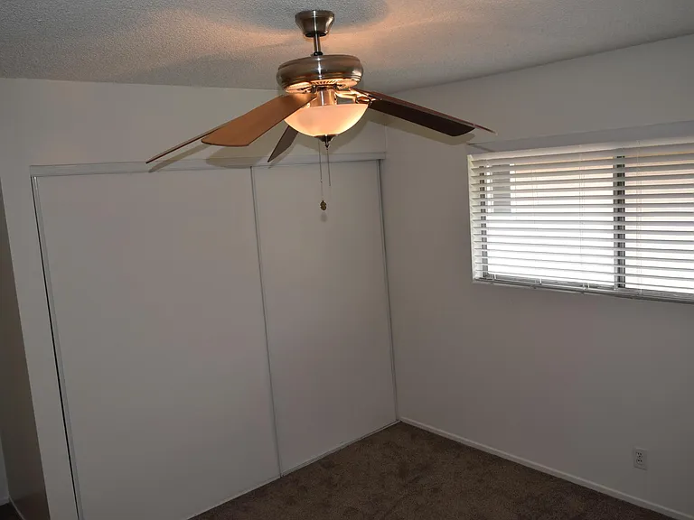 Guest Bedroom with Ceiling Fan and Large Closet