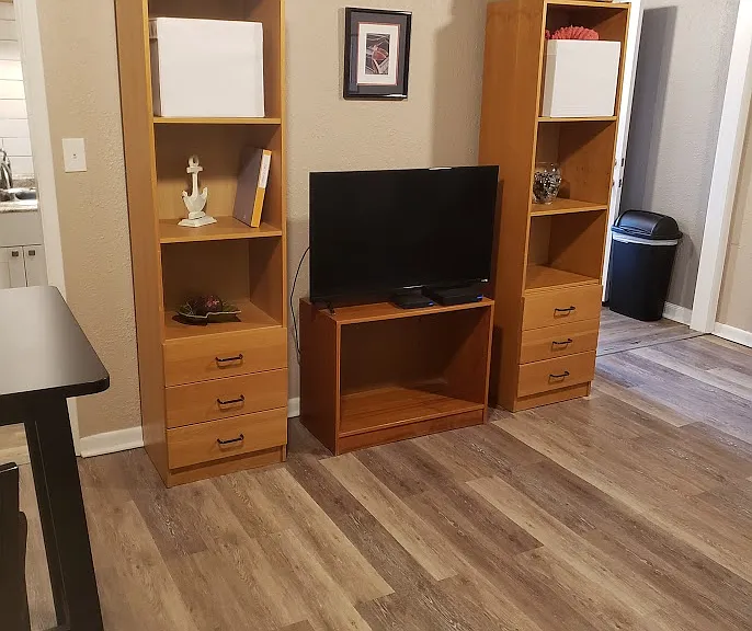 TV, tv stand and dressers can stay or go. View of Living room from bedroom's 2nd door.