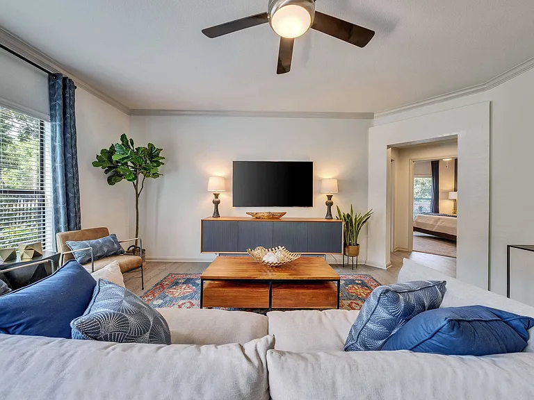 Spacious living room with ceiling fan