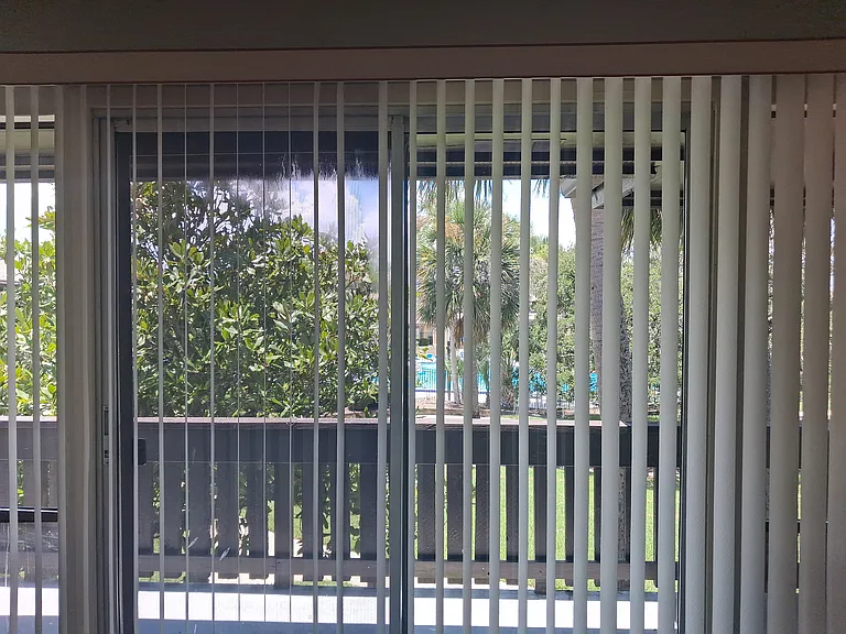 View from Living Room overlooking pool and access to the outside porch.