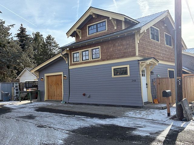 Home, to the left is a small hobby shop with extra engineered sound proofing, that is for the main house owners only. There is room for one car to park designated for the ADU. Home owners designed and built this unit for ultra energy efficiency.