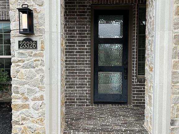 Covered front porch with built-in video doorbell.
