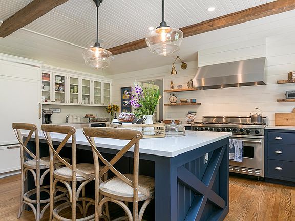 HUGE chef's kitchen is an entertainer's DREAM! This kitchen features a 48" professional-grade Viking 6-burner stove with stove-top grill and 2 ovens, a Sub-Zero fridge, 2 Bosch dishwashers, 2 porcelain farmhouse sinks and 4 under-counter garbage and recy