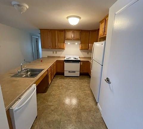 Kitchen with dishwasher, stove and fridge. Large pantry.