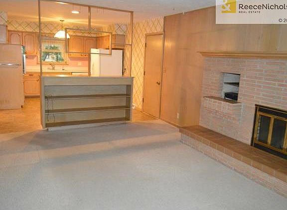 Family room adjacent to the kitchen, with a wood burning firepla