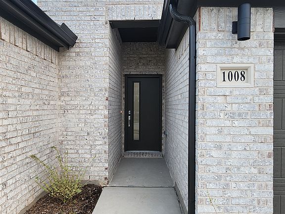 Front entryway with modern brick exterior and covered entrance.
