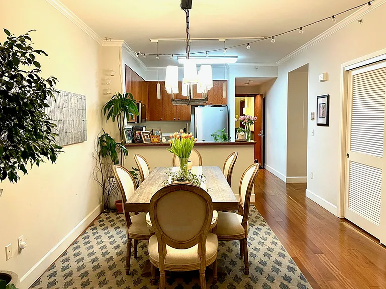 Dedicated dining area with custom chandelier and kitchen access.