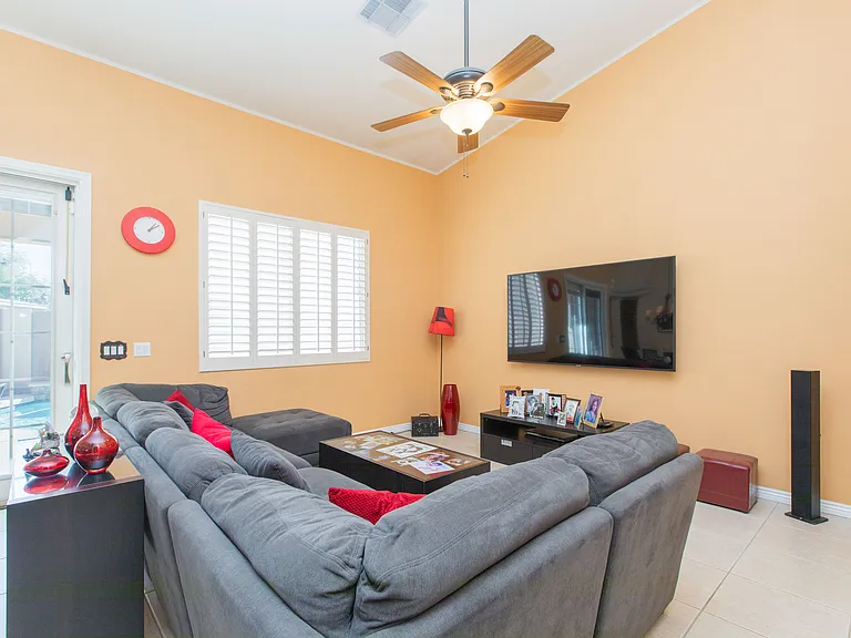 Family room view with patio door & window wood shutters
