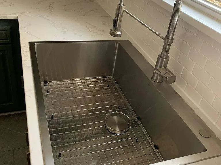 large stainless steel sink, tile backsplash
