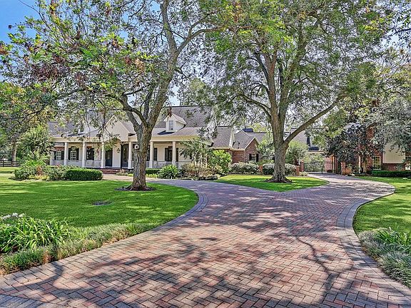 Both the circular drive and the path to the motor court and garages are finished with brick pavers. Even the porte cochere recieved an update with a new double iron gate and new columns.