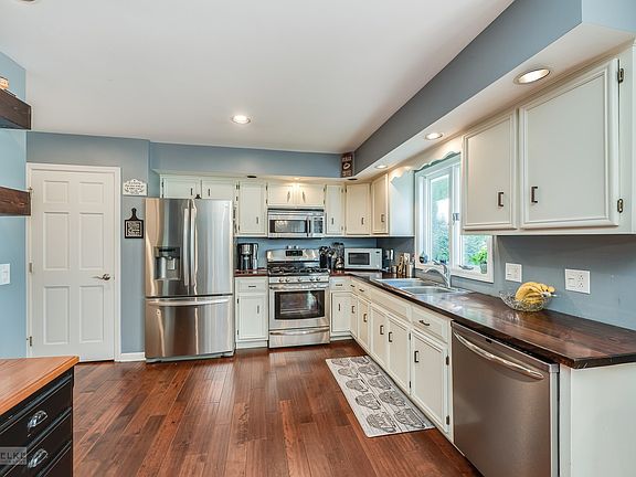 Dream kitchen features beautiful wood counter tops, SS appliances, recessed lighting & 2 pantries!