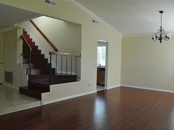 View from livingroom area to stairs, dinning room area, into kitchen