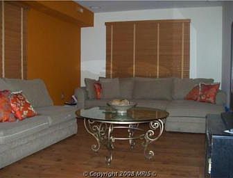 Living room has hardwood floors, surround sound and feature wall.