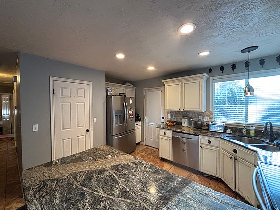 Door opens to walk in pantry, door to the right of the fridge opens out to the deck