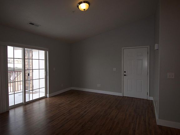 Living room with vaulted ceilings, wood floors