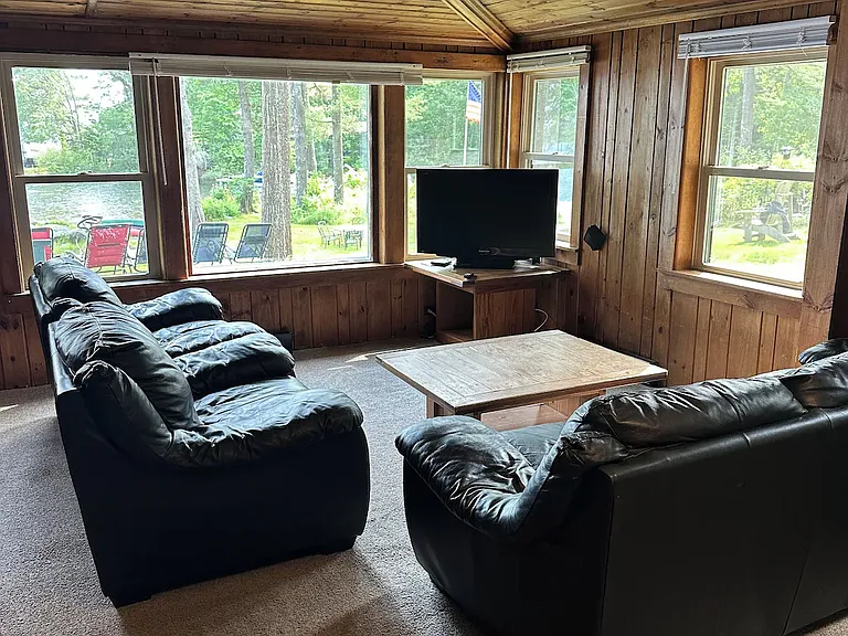 Living room has sweeping views across beach and lake. You can see all the way down Jordan Bay.