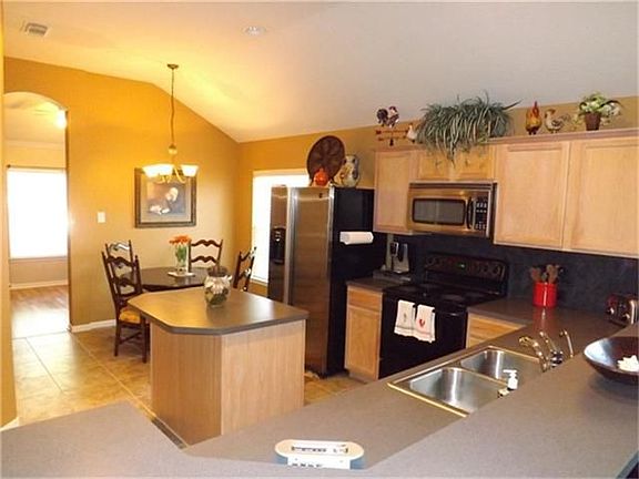 Light-filled kitchen looking into the breakfast area.