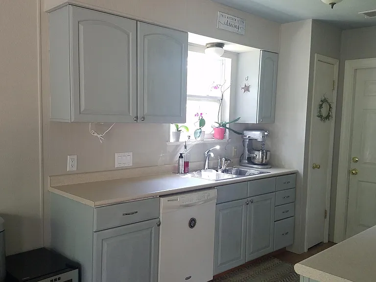 Kitchen with dishwasher, stove, microwave and fridge