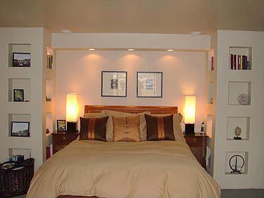 Custom art niches and lighting in master bedroom