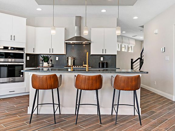 Modern kitchen with a large, granite kitchen island is perfect for enjoying your morning coffee or q