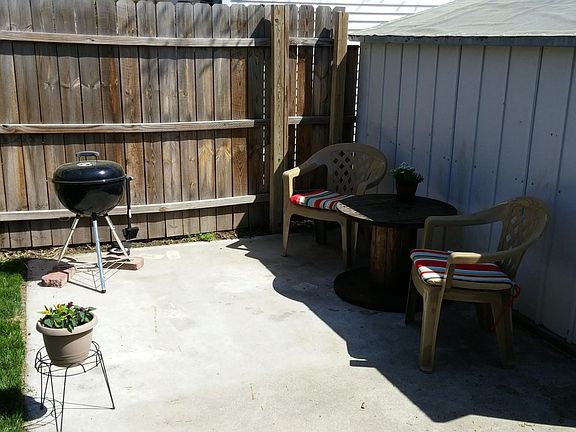 Patio & storage building in fenced backyard