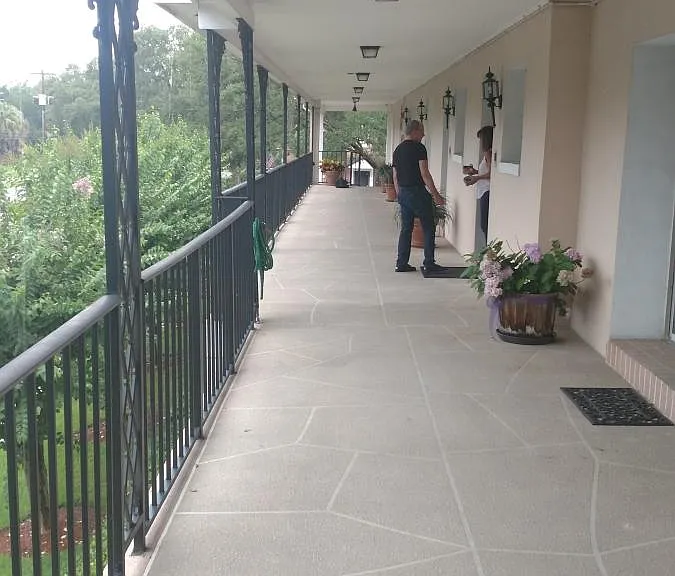 Second story big porch facing Riverside. I am located at the end, and closed in.