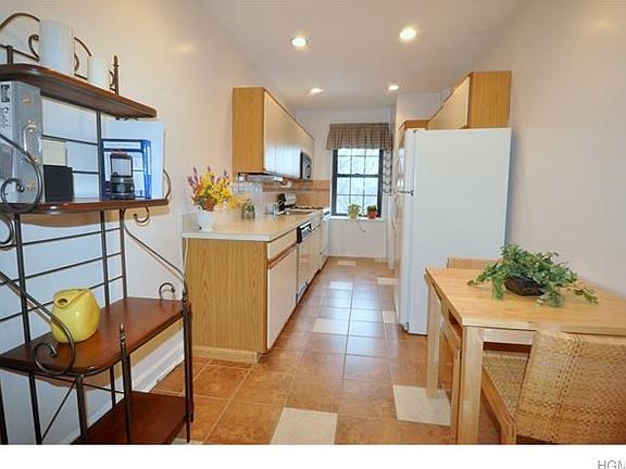 Updated Eat-in-Kitchen has a dishwasher, range microwave and refrigerator.  Plenty of counter space and views of Scarsdale.