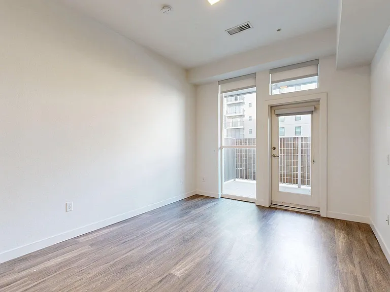 Apartment Living Room with Plank Flooring and Balcony.