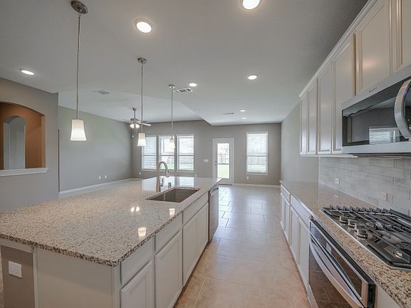 Spacious island kitchen with pendant lighting