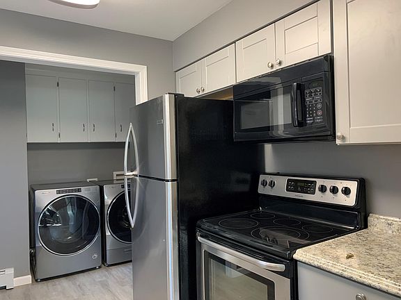 New stainless refrigerator, microwave with vent, and stove