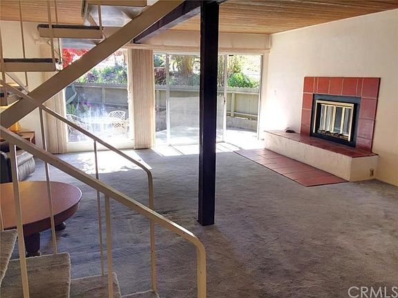 Entry into Living/dining room.  Wood burning fireplace with tile surround and hearth