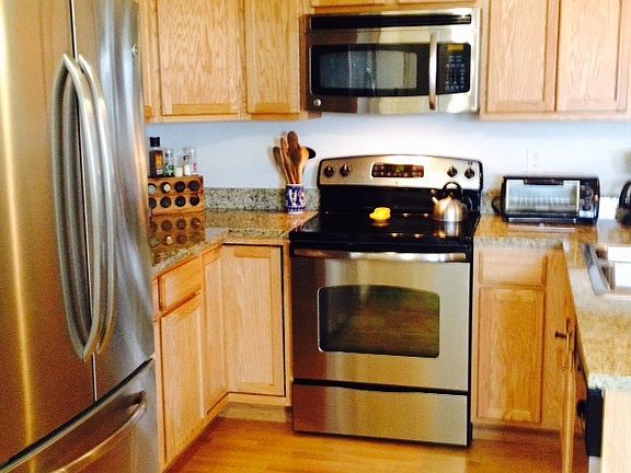 Kitchen has granite counters and stainless appliances