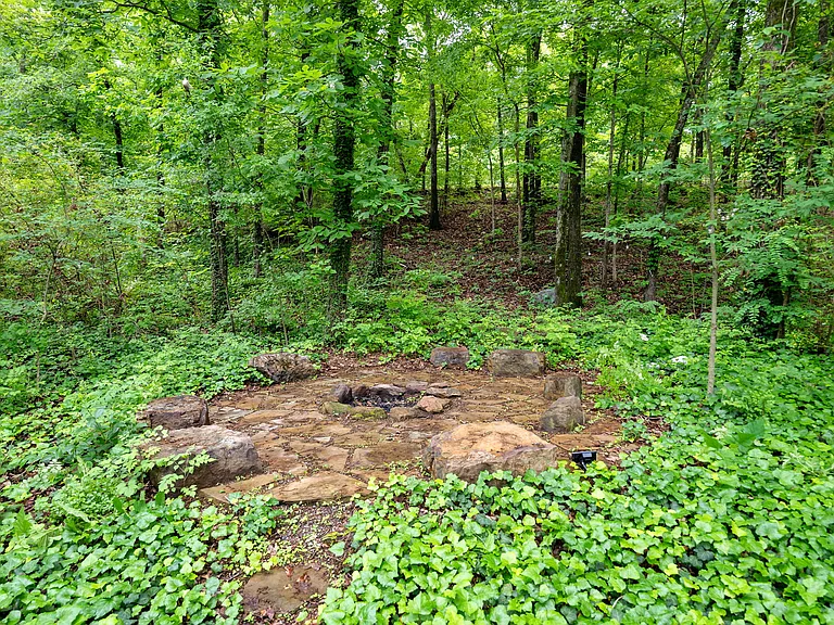 Firepit with stone seating, perfect for entertaining on crisp autumn nights!