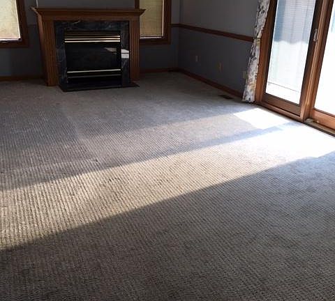 The living area is a private room where the TV can be on and not disturb the family. A gas fireplace adds ambiance and the sliding door accesses the patio.