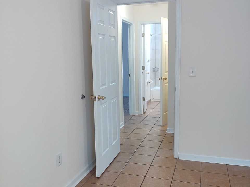 View to hallway from main bedroom - tiles throughout the apartment